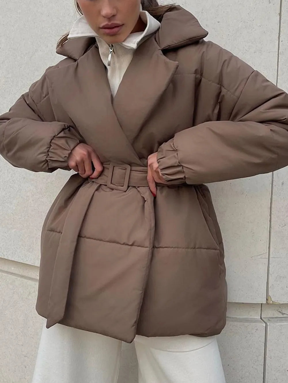 Puffer long sleeve winter coat with belt, featuring a stylish design and warm, padded material in a neutral brown tone.