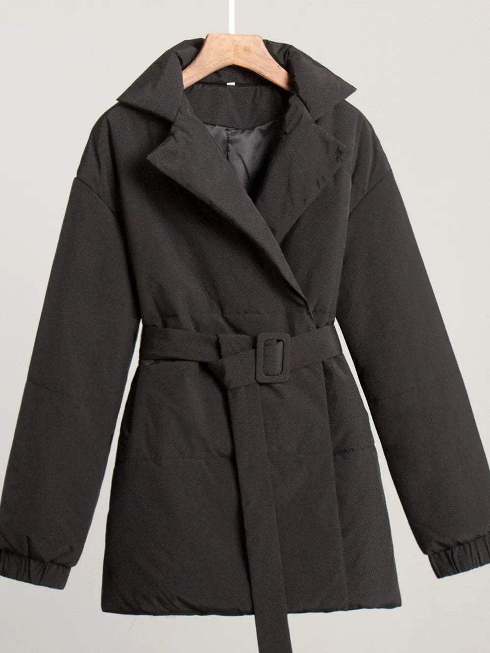 Puffer long sleeve winter coat in black with belt, normal thickness, made of 100% polyester.