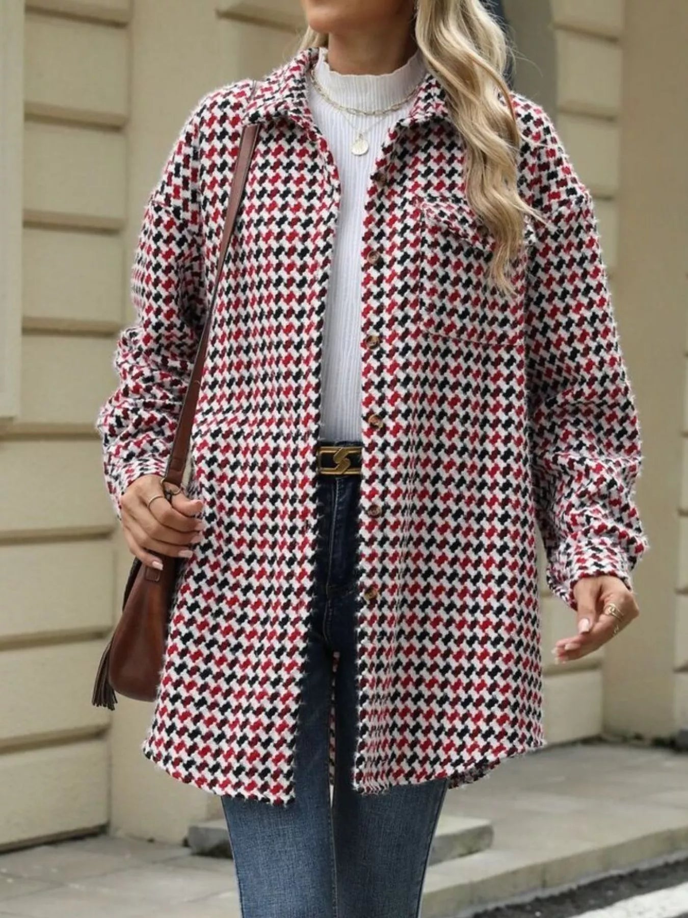 Houndstooth button-up long sleeve coat in black, red, and white, featuring a relaxed fit and pockets, perfect for casual style.