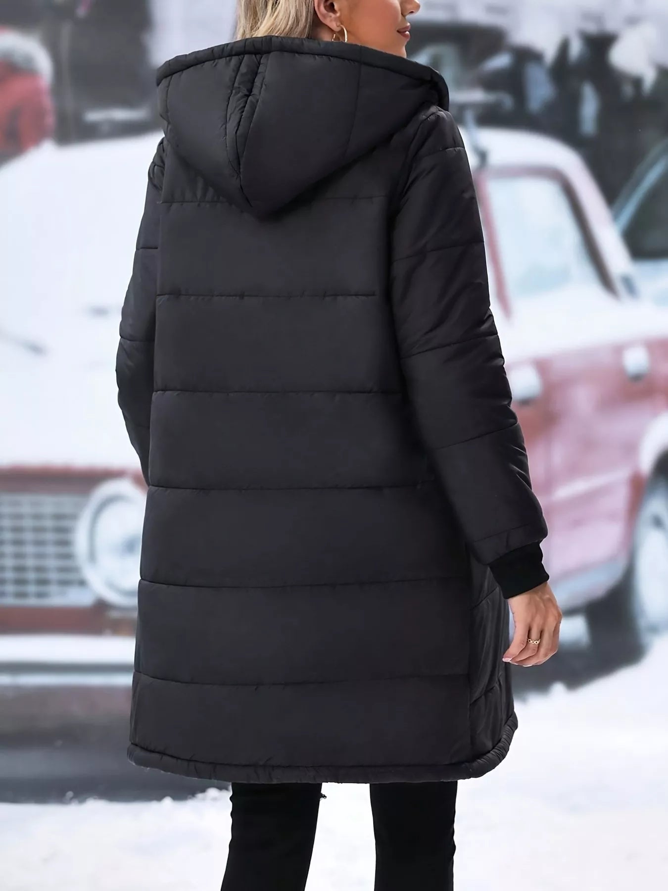 Back view of a black quilted zip up puffer coat with hood, perfect for winter wear.