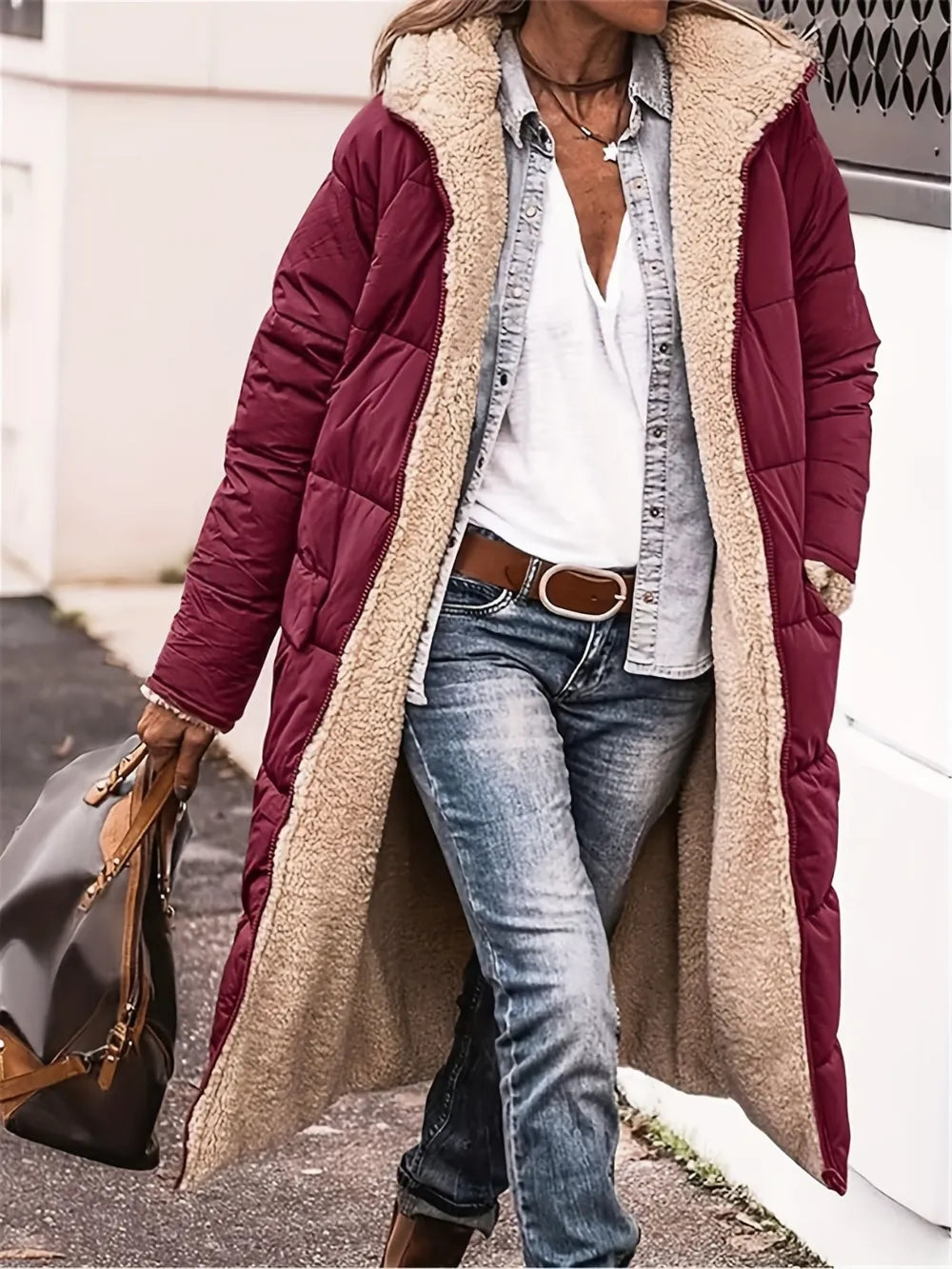 Woman wearing a full-size zip-up sherpa hooded coat in burgundy, styled with jeans and a casual top.