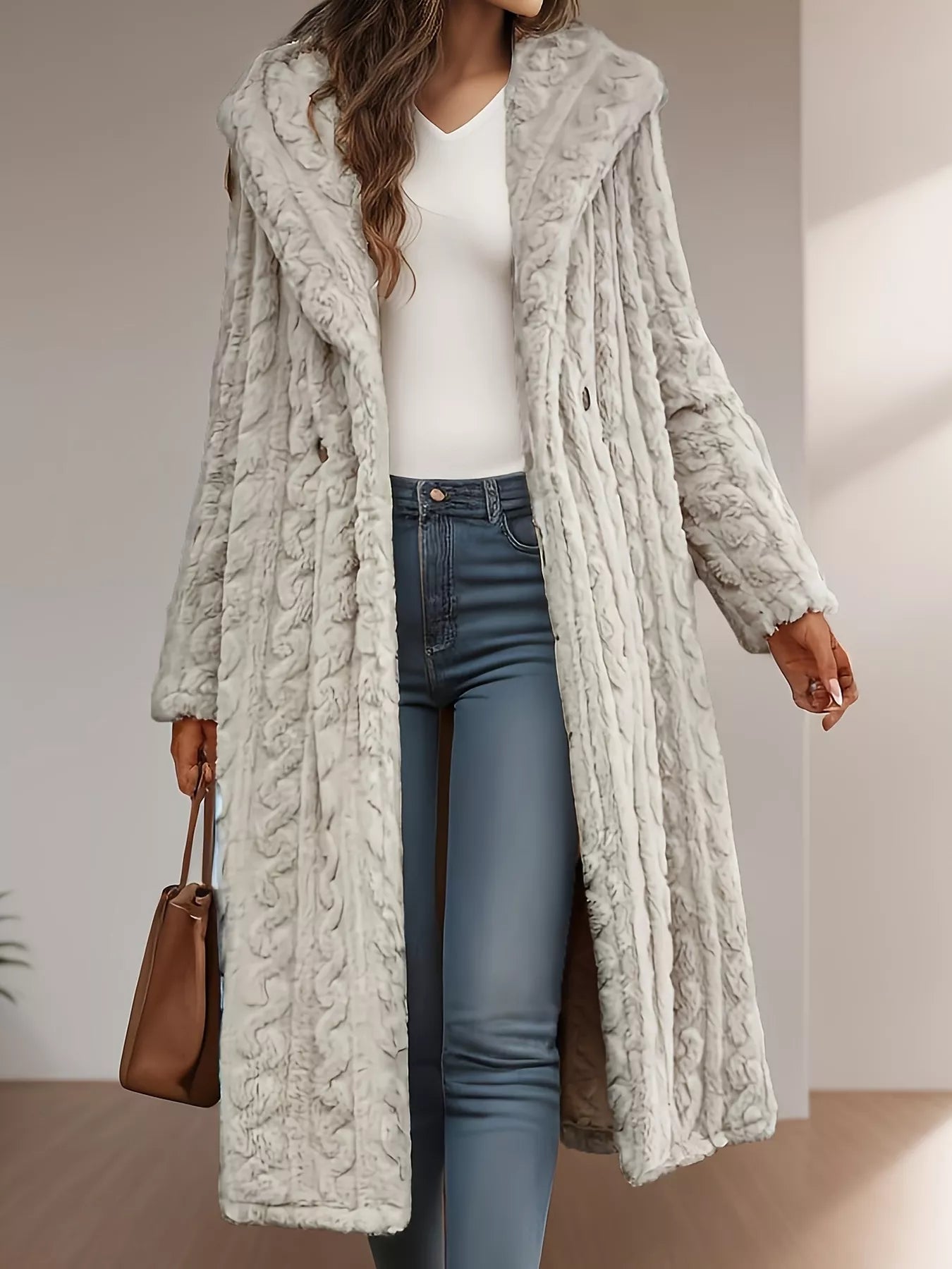 Elegant Sherpa longline hooded coat in light gray, featuring a textured design, worn over jeans, perfect for winter style.