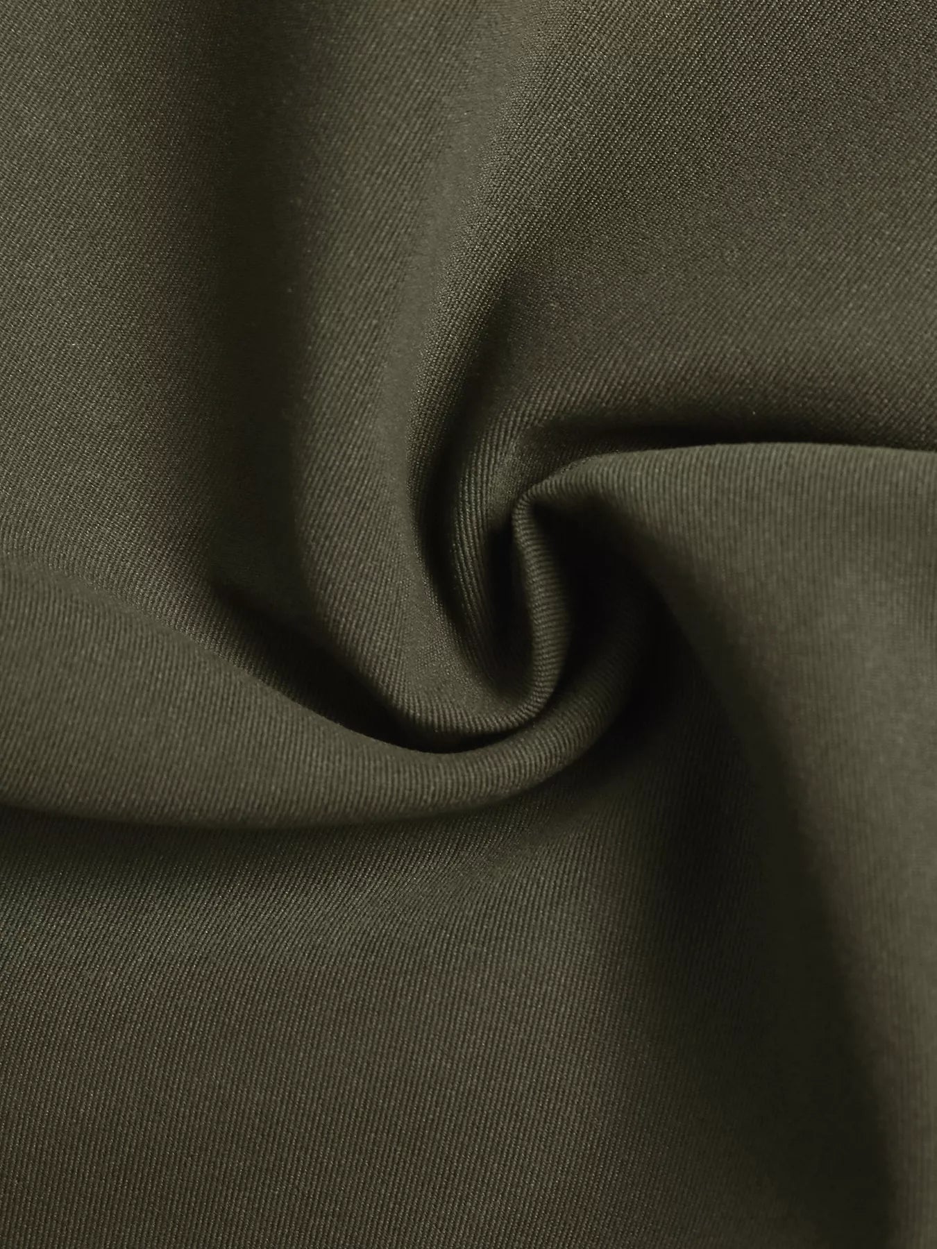 Close-up of olive green polyester fabric, showcasing a smooth texture and rich color for fashion designs.