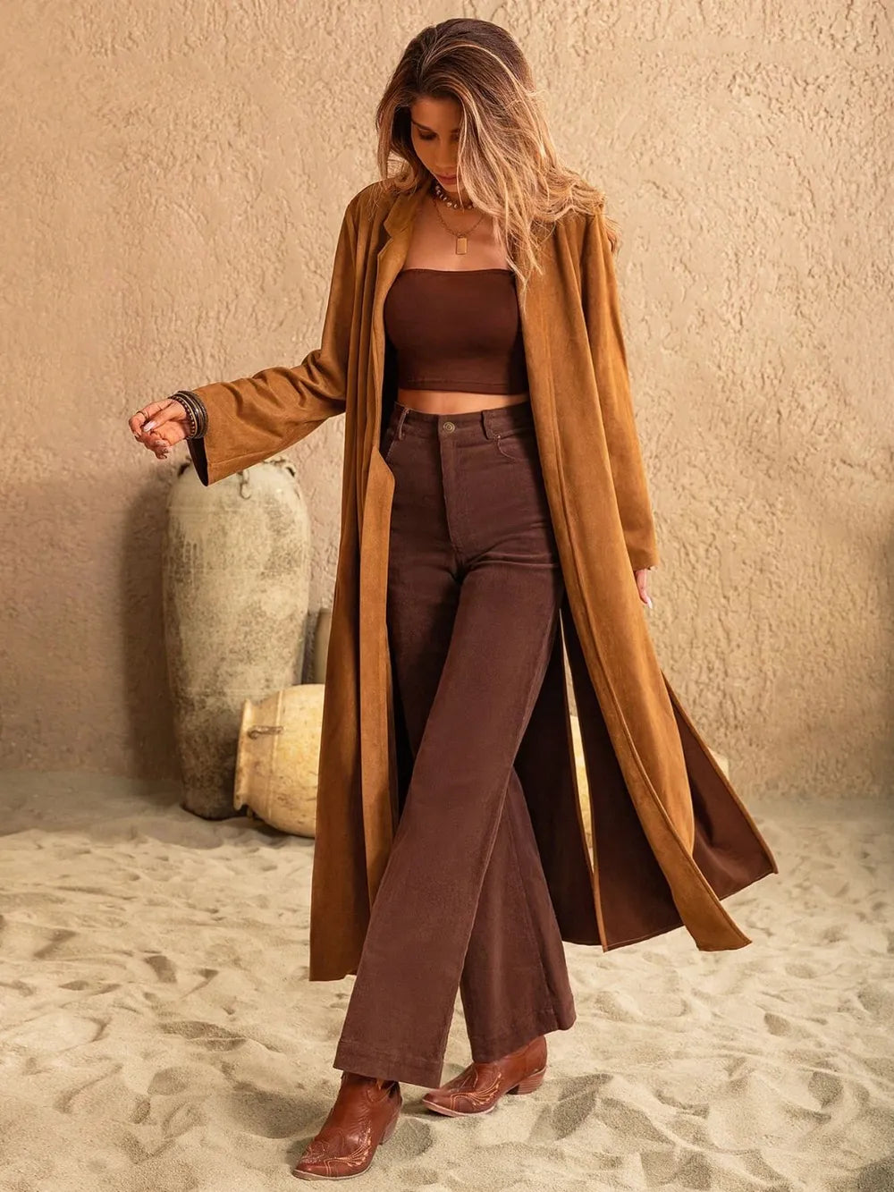 Model wearing a brown longline coat over a matching outfit, showcasing a stylish and casual desert look.