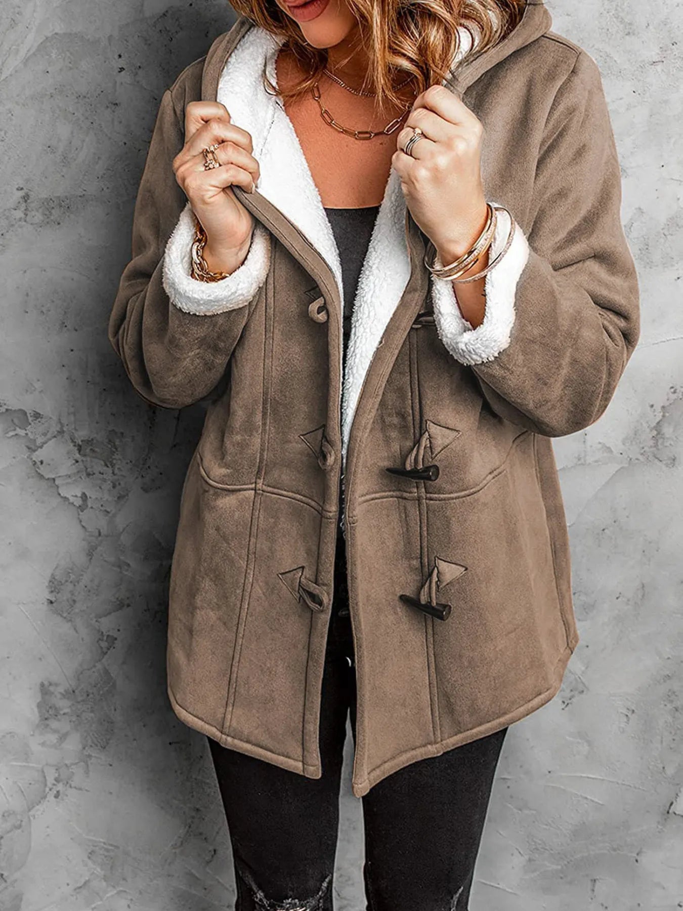 Women wearing a cozy sherpa lined toggle coat with hood, perfect for chilly weather, featuring a stylish design.