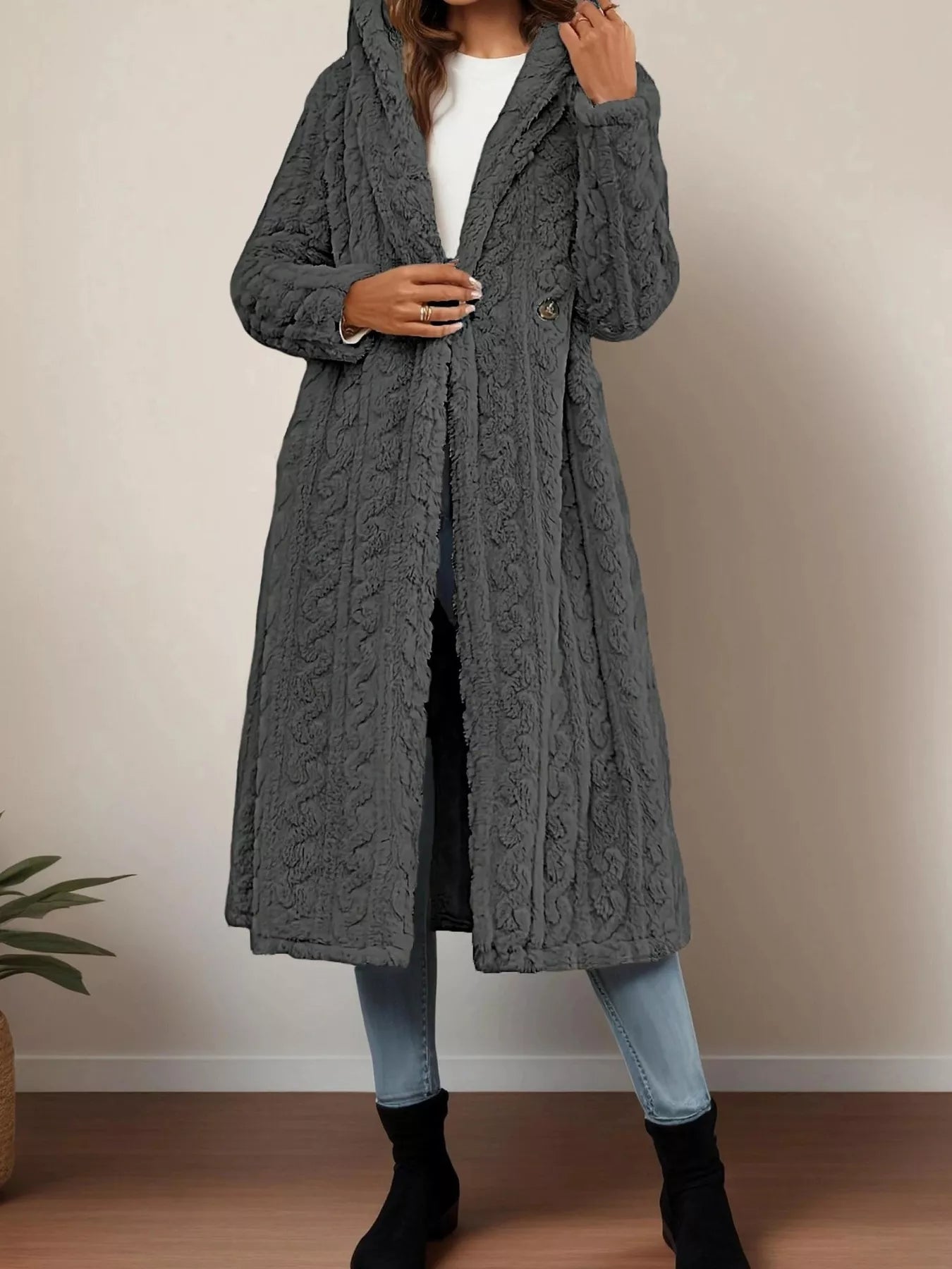 Sherpa longline hooded coat in gray, textured knit, featuring a buttoned front, modeled with jeans and boots.
