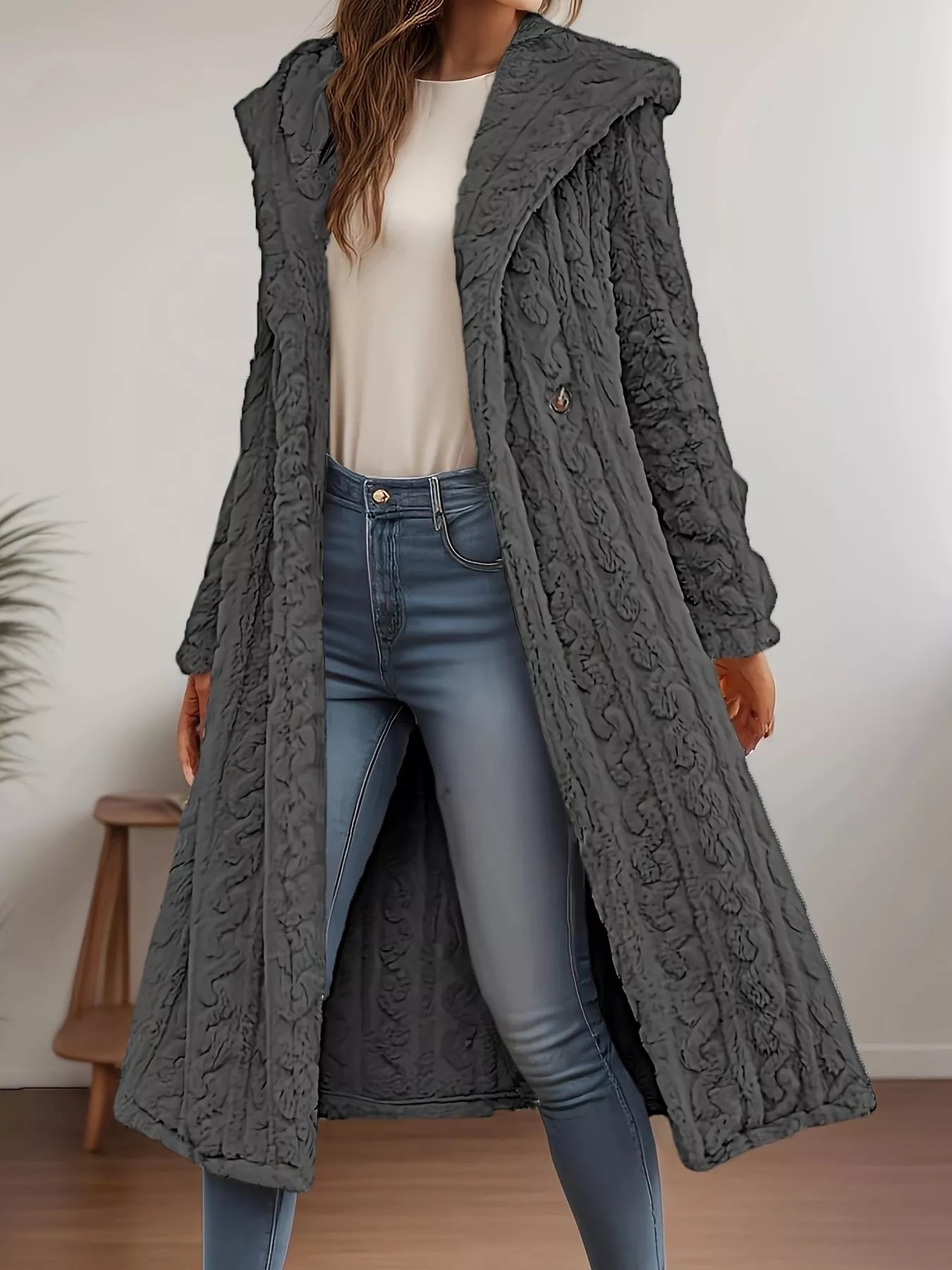 Sherpa longline hooded coat in gray worn over a white top and jeans, showcasing its thick, textured design.