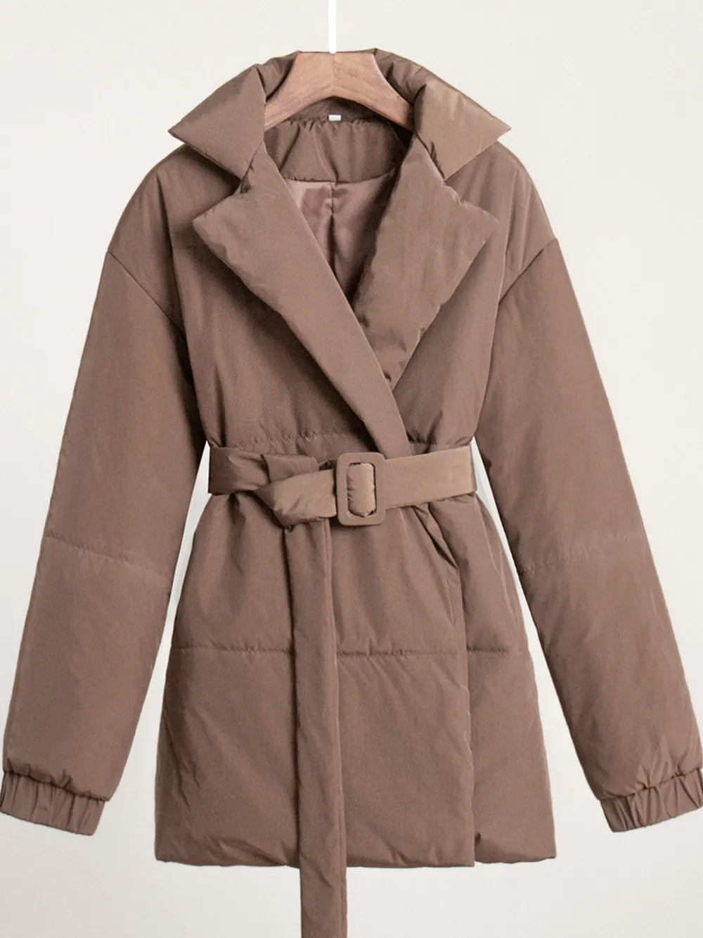 Brown puffer long sleeve winter coat with belt, 100% polyester, machine washable, stylish and cozy for cold weather.
