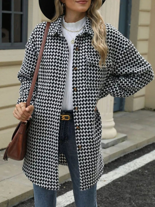 Woman wearing a houndstooth button-up long sleeve coat with a handbag, stylish street fashion.