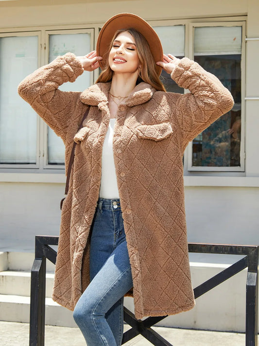 Smiling woman in a cozy beige button-up coat with pockets, enjoying a sunny day outdoors.
