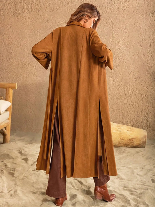 Model wearing a longline slit tied collared neck coat in brown, showcasing its stylish back and relaxed fit.